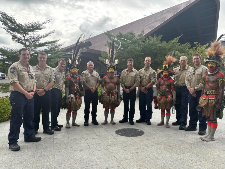PNG dancers in traditional dress with Australian aid workers