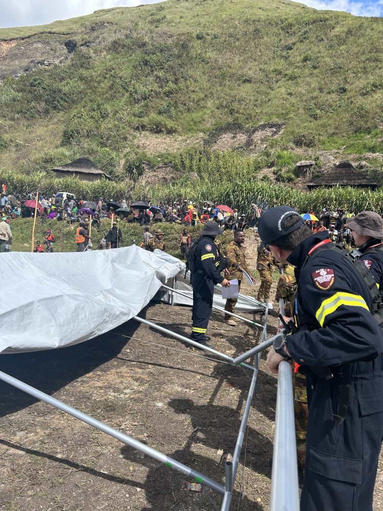Aid workers put together a marquee